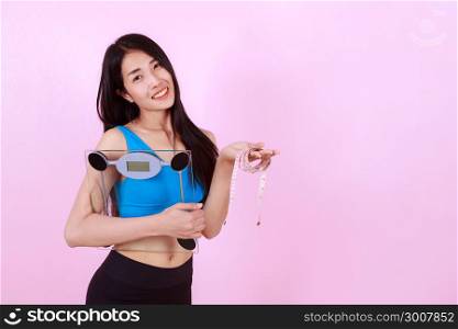 happy slim woman holding a weight scale