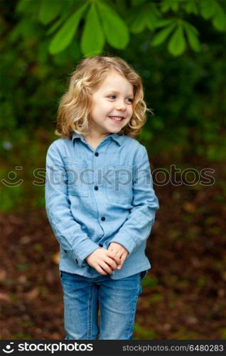 Happy small child enjoying the nature. Happy small child with long blond hair enjoying the nature