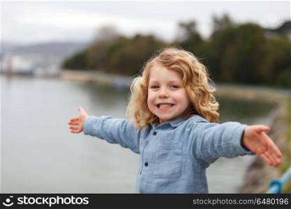 Happy small child with long blond hair enjoying the holidays