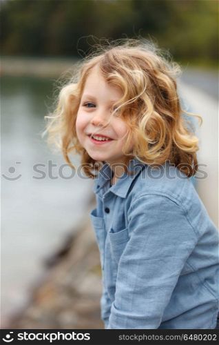 Happy small child with long blond hair enjoying the holidays
