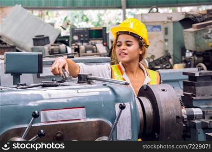 Happy smile female mechanical engineer or employee worker with yellow safety helmet in a factory. Happy Work.