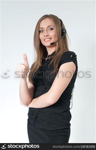Happy smiling attractive call center operator. Sexy girl wearing headset. Showing big finger super sign. One of a series.