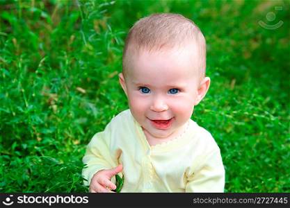 happy smiling baby sitting in grass