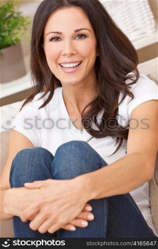 Happy Smiling Beautiful Woman Sitting on Sofa