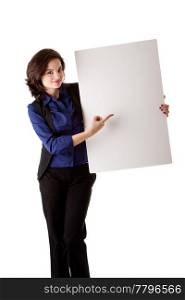 Happy smiling beautiful young caucasian brunette business student woman standing next to and holding a white blank board and pointing at it, isolated