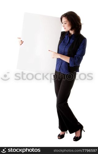 Happy smiling beautiful young caucasian brunette business student woman standing next to and holding a white blank board and pointing at it, isolated