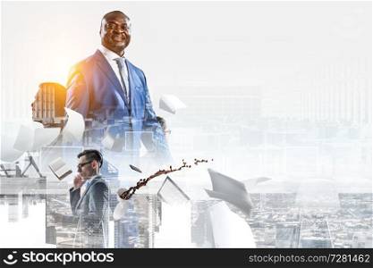 Happy smiling black businessman company leader in blue suit standing with a few white men surrounded by laptop, spilled coffee, notebook with cityscape background. Smiling black businessman standing with other white businesmen, office objects and cityscape background