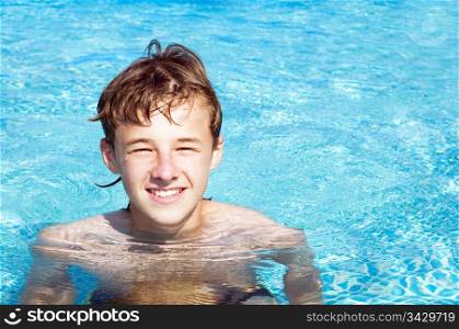 Happy smiling boy in a pool