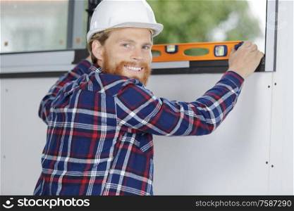 happy smiling constructor holding tool