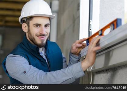 happy smiling constructor holding tool