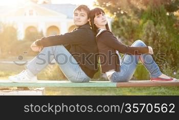 happy smiling couple against sun lite