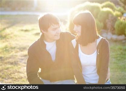 happy smiling couple against sun lite