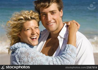 Happy smiling couple embracing on Maui, Hawaii beach.