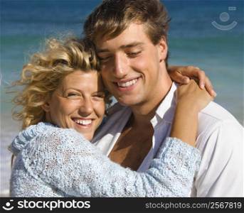 Happy smiling couple embracing on Maui, Hawaii beach.