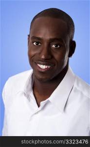 Happy smiling face of a handsome African American business man wearing a white shirt, isolated.