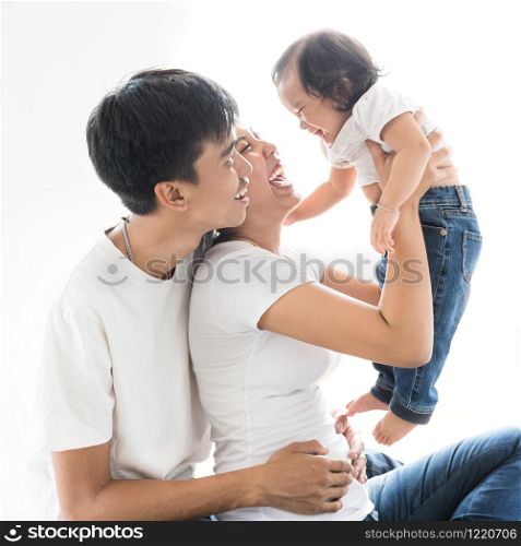 happy smiling family three people father mother and daughter ware white cloth blue jean trouser isolated on white background