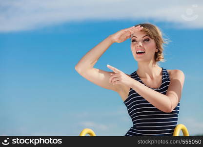 Happy smiling fashion young woman in striped dress outdoor. Pretty gorgeous girl relaxing enjoying summer vacation.