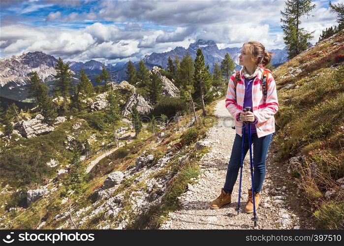 happy smiling girl hiker at the mountains Dolomites, Italy. Cinque Torri