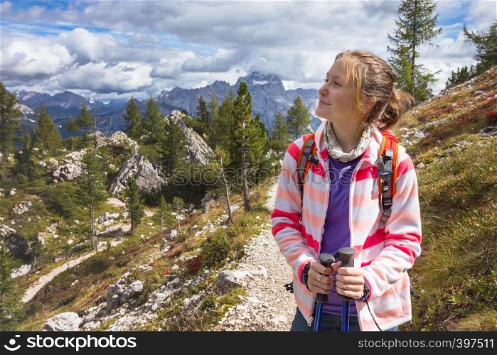 happy smiling girl hiker at the mountains Dolomites, Italy. Cinque Torri