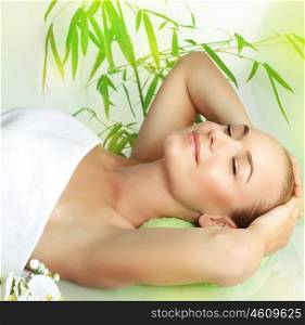 Happy smiling girl with closed eyes lying down on massage table in a spa salon, beauty treatment, pampering and skin care&#xA;