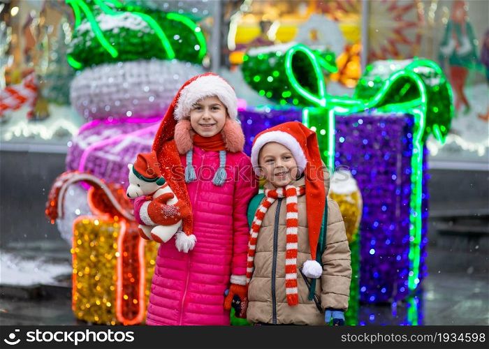 Happy smiling kids with gift over Christmas background. Christmas concept. Gifts from Santa.. Happy smiling kids with gift over Christmas background. Christmas concept.