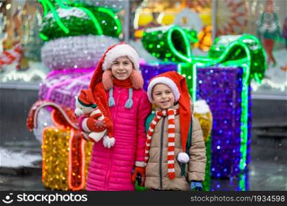 Happy smiling kids with gift over Christmas background. Christmas concept. Gifts from Santa.. Happy smiling kids with gift over Christmas background. Christmas concept.