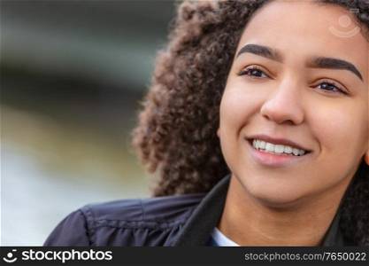 Happy smiling mixed race African American girl or young woman with perfect teeth