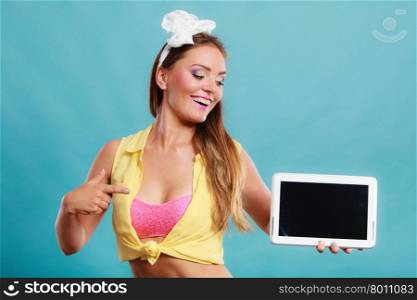 Happy smiling pin up girl holding tablet computer with blank screen copyspace. Retro woman advertising new modern technology. Old vintage fashion.