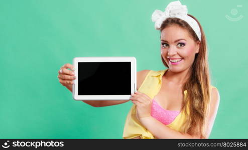 Happy smiling pin up girl holding tablet computer with blank screen copyspace. Retro woman advertising new modern technology. Old vintage fashion.