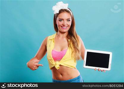 Happy smiling pin up girl holding tablet computer with blank screen copyspace. Retro woman advertising new modern technology. Old vintage fashion.