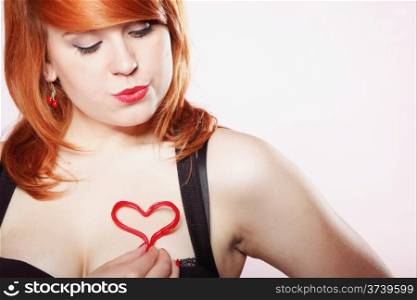 happy smiling redhair young girl holding one little red heart love symbol . Concept of valentine&#39;s day