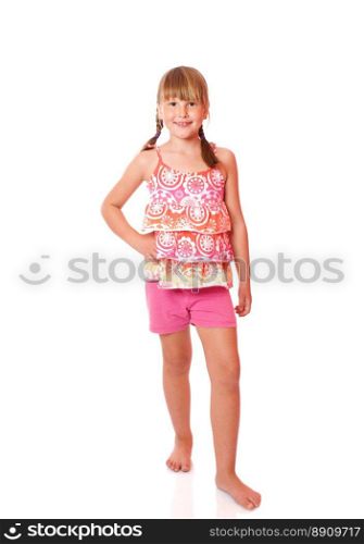 Happy smiling seven years girl standing isolated on white