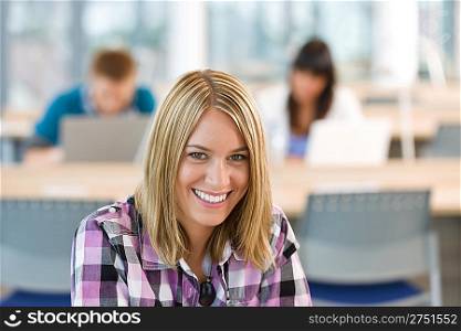 Happy smiling student study in classroom at university, schoolmates in background