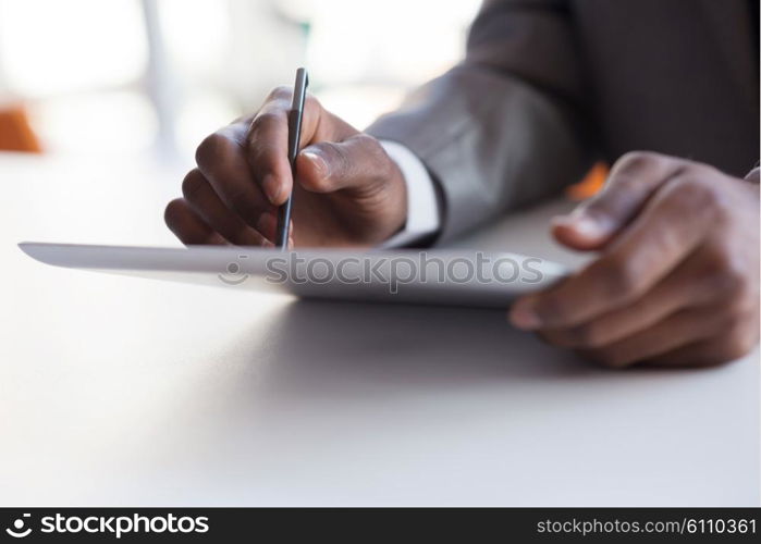 Happy smiling successful African American businessman in a suit in a modern bright office indoors