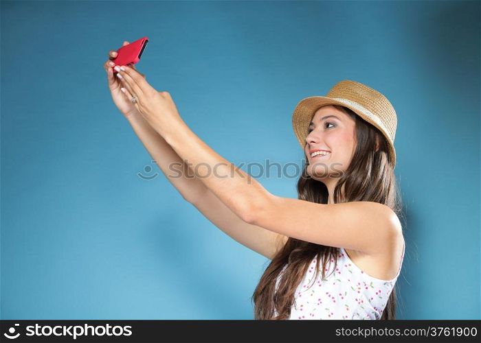 Happy smiling summer girl with smartphone mobile phone taking photo of herself