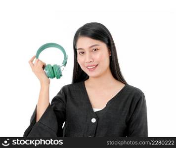 Happy smiling woman in black dress holding green headphones in her hand isolated on white background