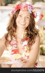 Happy smiling woman wearing hawaiian flowers garland on the beach. Summer vacations concept