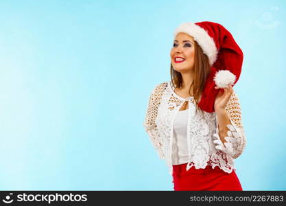 Happy smiling woman wearing red white color christmas clothing, santa claus hat. Girl ready for holiday season.. Smiling woman in christmas santa hat