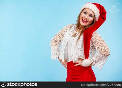 Happy smiling woman wearing red white color christmas clothing, santa claus hat. Girl ready for holiday season.. Smiling woman in christmas santa hat