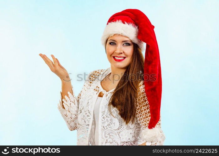 Happy smiling woman wearing red white color christmas clothing, santa claus hat. Girl ready for holiday season.. Smiling woman in christmas santa hat