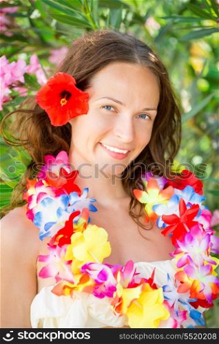 Happy smiling woman with flower lei garland of orchids. Summer vacations concept
