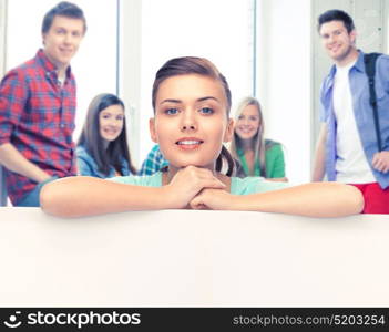 happy smiling woman with white blank board at school. woman with white blank board at school