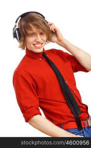 Happy smiling young man dancing and listening to music