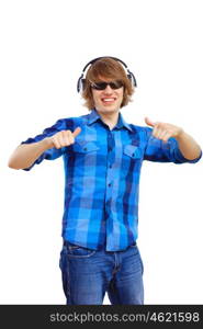 Happy smiling young man dancing and listening to music