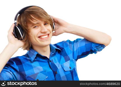 Happy smiling young man dancing and listening to music