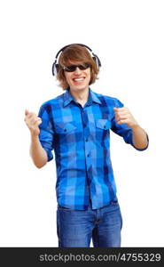 Happy smiling young man dancing and listening to music