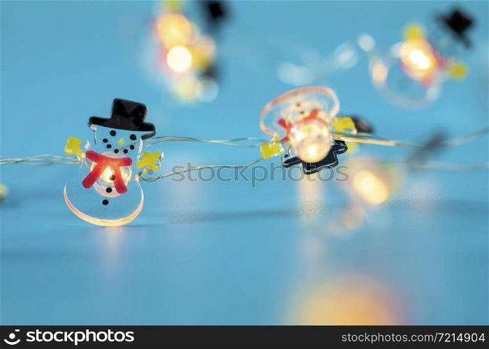 Happy Snowman lights on blue background, Winter and Christmas concept with copy space retro design glowing lights. Happy Snowman lights on blue background, Winter and Christmas concept with copy space retro design