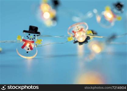 Happy Snowman lights on blue background, Winter and Christmas concept with copy space retro design glowing lights. Happy Snowman lights on blue background, Winter and Christmas concept with copy space retro design