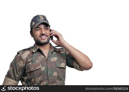 Happy soldier having conversation on mobile phone