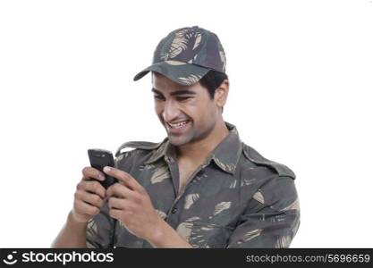 Happy soldier text messaging